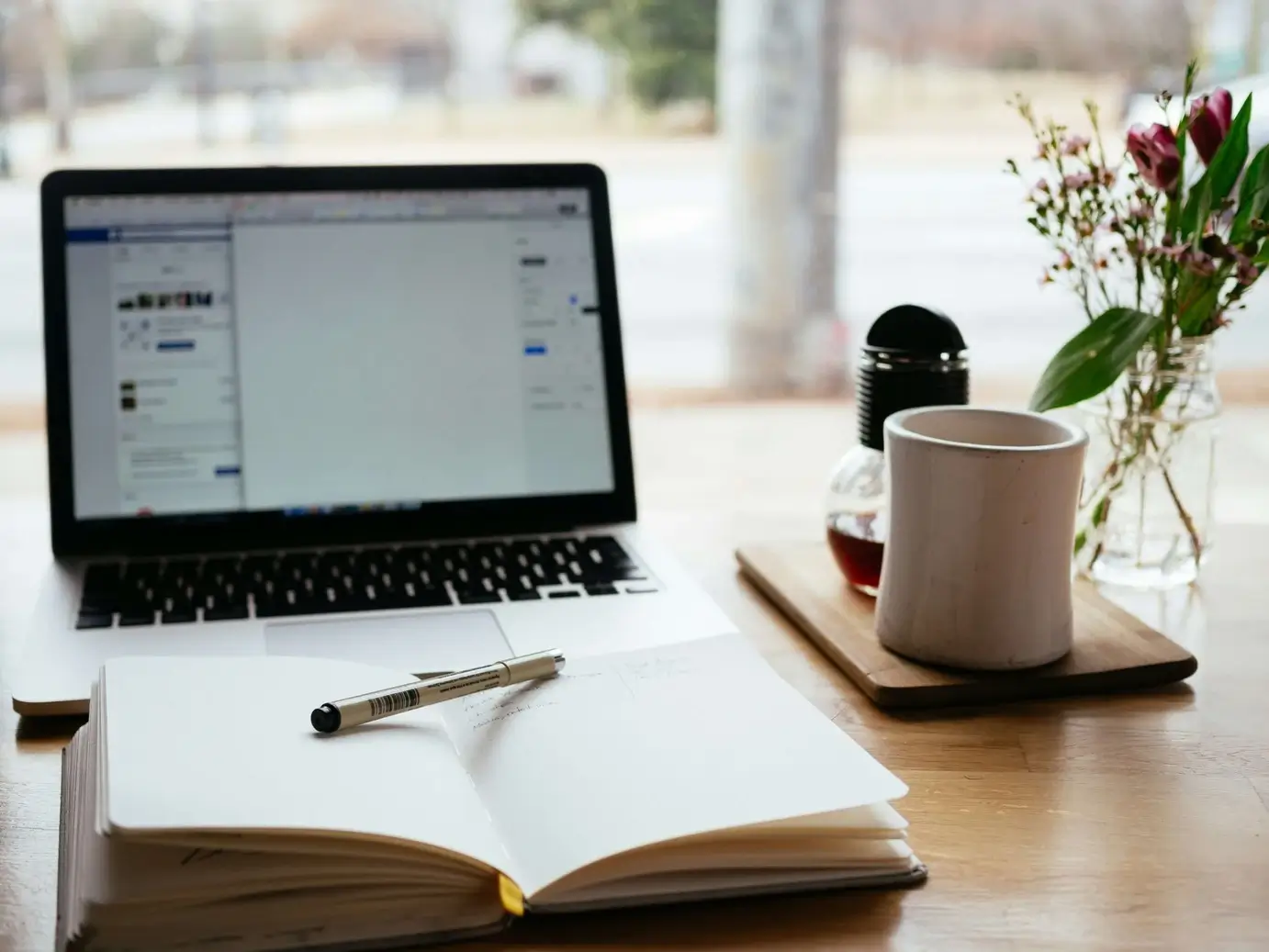 Laptop and a coffee cup on a desk